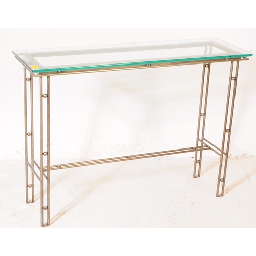 654 - A 20th century Italian manner metal and glass console hall table. The table featuring a metal frame,... 