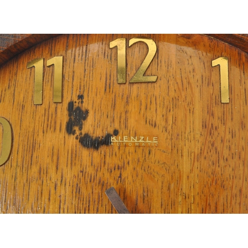 655 - A mid 20th century Kienzle barrel wall clock. The clock in the form of the top of a coopered barrel,... 