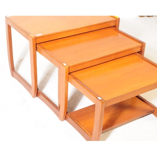 658 - British Modern Design - A mid 20th century teak wood nest of tables. The nest featuring three tables... 