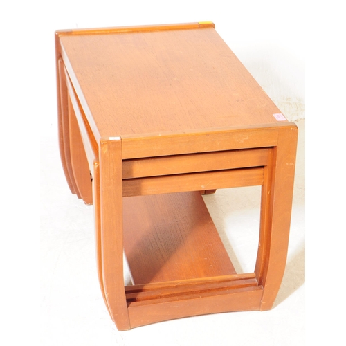 658 - British Modern Design - A mid 20th century teak wood nest of tables. The nest featuring three tables... 