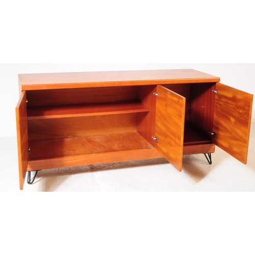 659 - British Modern Design - A mid 20th century teak wood sideboard. The sideboard raised on ebonised hai... 