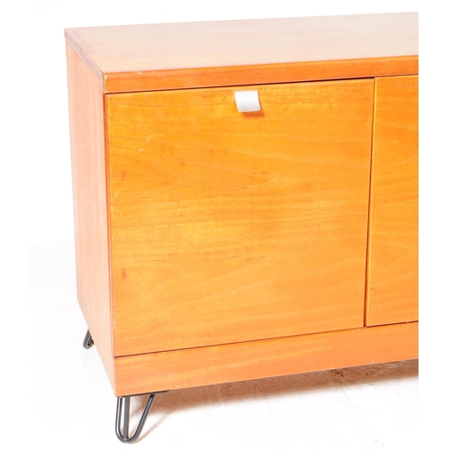 659 - British Modern Design - A mid 20th century teak wood sideboard. The sideboard raised on ebonised hai... 