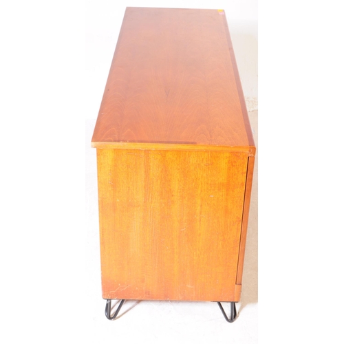 659 - British Modern Design - A mid 20th century teak wood sideboard. The sideboard raised on ebonised hai... 