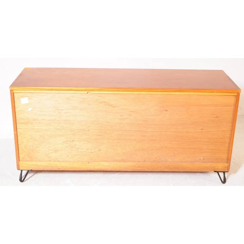 659 - British Modern Design - A mid 20th century teak wood sideboard. The sideboard raised on ebonised hai... 