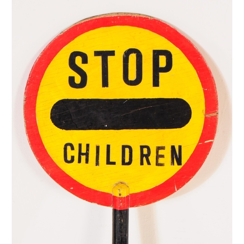 664 - A vintage 20th century lollipop lady's hand held wooden sign. The sign circular with red border & ye... 