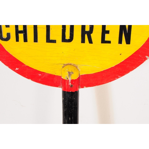 664 - A vintage 20th century lollipop lady's hand held wooden sign. The sign circular with red border & ye... 