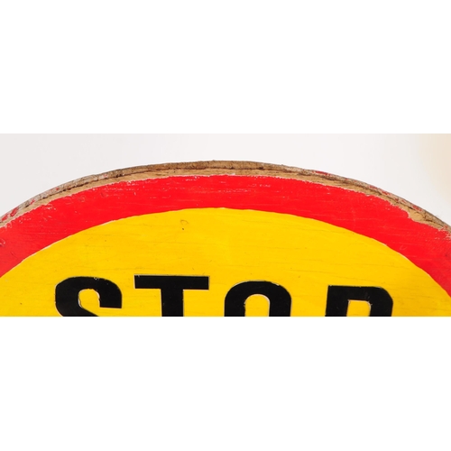 664 - A vintage 20th century lollipop lady's hand held wooden sign. The sign circular with red border & ye... 