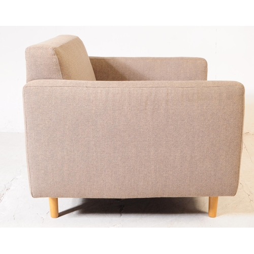 684 - Case - Italy - A contemporary armchair with grey oversized button back seat and square slap elbow re... 