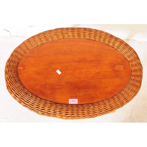 687 - British Modern Design - A vintage mid century oval occasional / coffee table. With rattan rim and ta... 