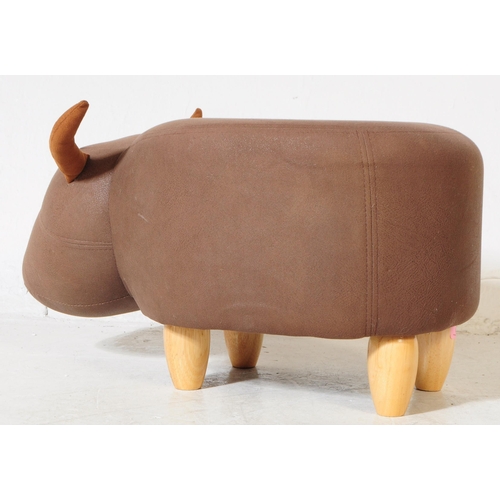 689 - A contemporary faux leather footstool ottoman in bull / cow form. All raised on turned wooden legs. ... 