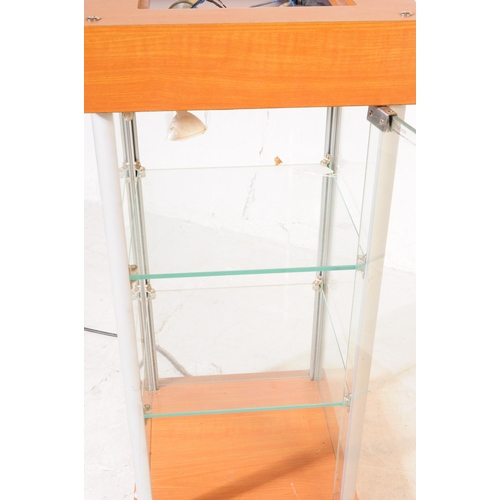 698 - A late 20th century shop front point of sale display cabinet. The cabinet raised on a plinth base, w... 