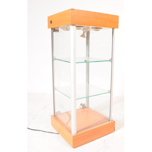 698 - A late 20th century shop front point of sale display cabinet. The cabinet raised on a plinth base, w... 