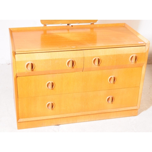 706 - British Modern Design - A mid 20th century oak veneer dressing chest of drawers. The chest of drawer... 