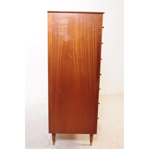 715 - British Modern Design - A mid 20th century circa 1960s teak chest of drawers having a series of seve... 