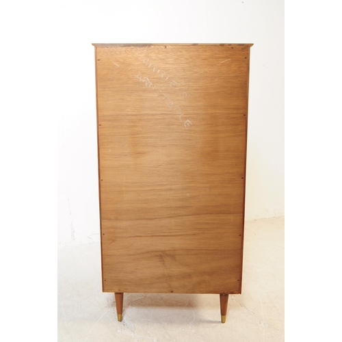 715 - British Modern Design - A mid 20th century circa 1960s teak chest of drawers having a series of seve... 