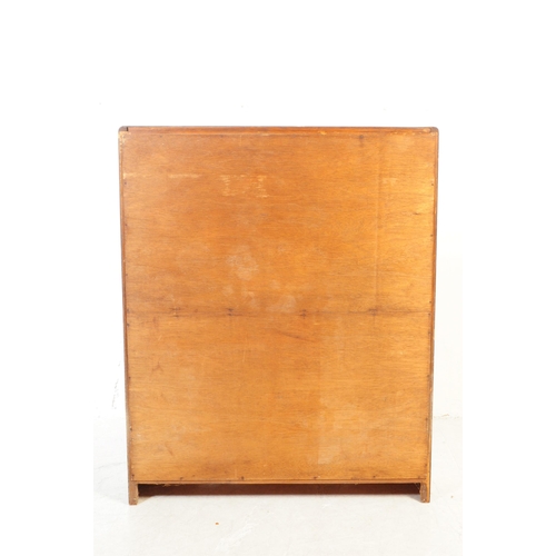 716 - British Modern Design - A mid 20th century oak glazed display cabinet having twin glazed doors openi... 