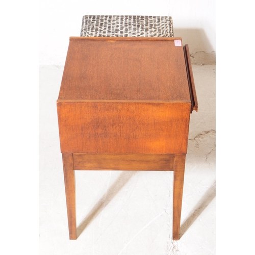 718 - British Modern Design - A mid 20th century circa 1960s teak Chippy telephone seat. The seat having d... 