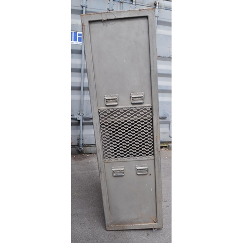 747 - A 20th Century retro industrial metal storage two door locker cage raised on castor wheels. Of recta... 