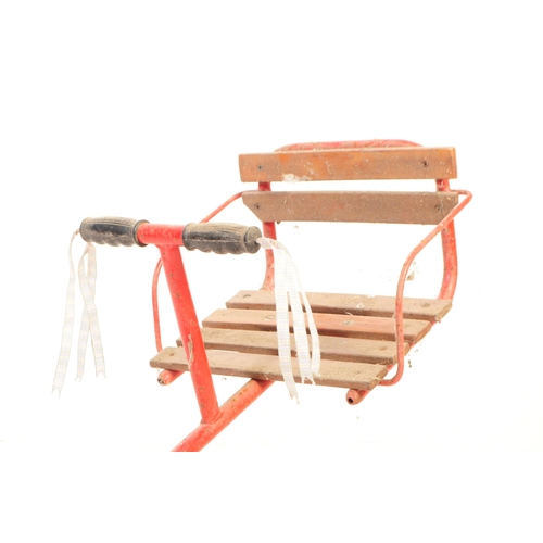 749 - A mid Century vintage children's outdoor metal seesaw painted red with wooden slatted seats having m... 