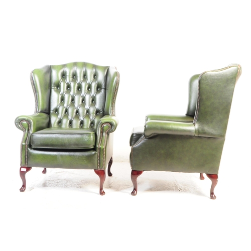 801 - Contemporary pair of green chesterfield wing back lounge Queen Anne armchairs. Having the green butt... 