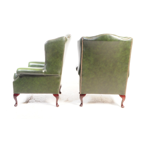 801 - Contemporary pair of green chesterfield wing back lounge Queen Anne armchairs. Having the green butt... 