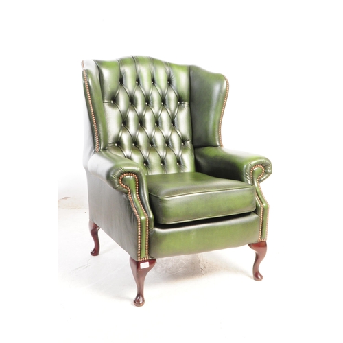 801 - Contemporary pair of green chesterfield wing back lounge Queen Anne armchairs. Having the green butt... 