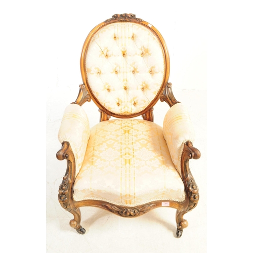 804 - A 19th century Victorian carved walnut Gentlemen's spoon back armchair. With button cushioned back d... 