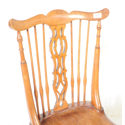 807 - A 19th century ash and elm Windsor chair. With top rail moustache style top into pierced splat spind... 