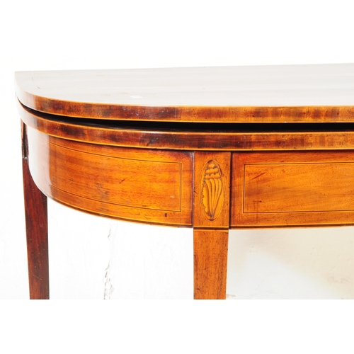 811 - A 19th century George III mahogany inlaid conch shell tea table. Of curved rectangular form with fol... 