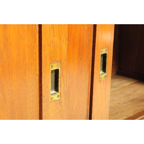 812 - A 20th century mahogany sideboard / credenza. Of rectangular form with flared top, over three slidin... 