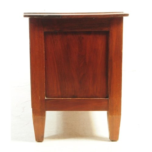 812 - A 20th century mahogany sideboard / credenza. Of rectangular form with flared top, over three slidin... 