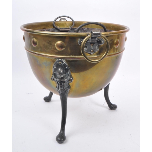 1003 - A 19th century Victorian brass and iron cauldron / pot. With ring carry handles, embossed circular d... 