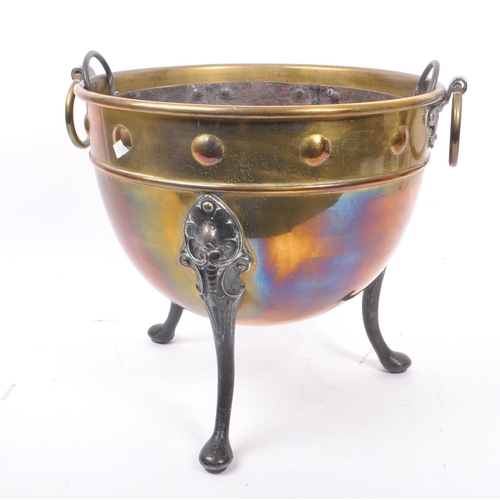 1003 - A 19th century Victorian brass and iron cauldron / pot. With ring carry handles, embossed circular d... 