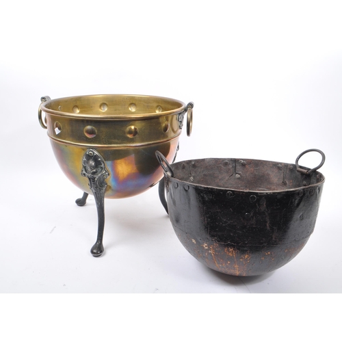 1003 - A 19th century Victorian brass and iron cauldron / pot. With ring carry handles, embossed circular d... 