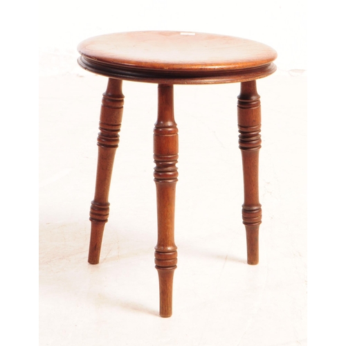 817 - A small Victorian 19th Century mahogany milking stool raised on three turned legs, together with an ... 