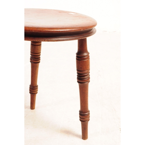 817 - A small Victorian 19th Century mahogany milking stool raised on three turned legs, together with an ... 