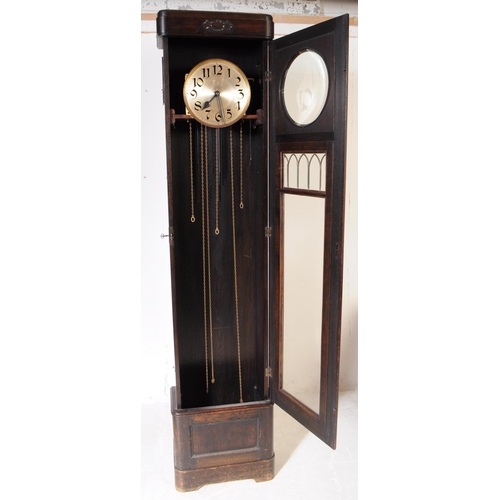 820 - An early 20th century circa 1930s Art Deco oak wood longcase grandfather clock. The clock raised on ... 