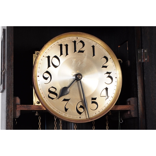 820 - An early 20th century circa 1930s Art Deco oak wood longcase grandfather clock. The clock raised on ... 