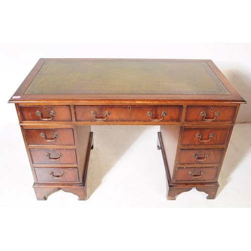 821 - A 19th century revival mahogany pedestal desk. The desk raised on twin pedestals, each having bracke... 