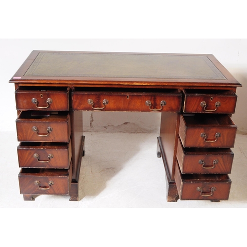 821 - A 19th century revival mahogany pedestal desk. The desk raised on twin pedestals, each having bracke... 