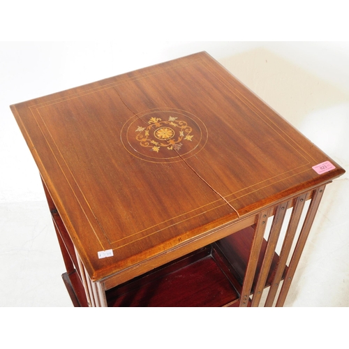 823 - An early 20th century Edwardian walnut revolving bookcase cabinet, alongside another similar desktop... 