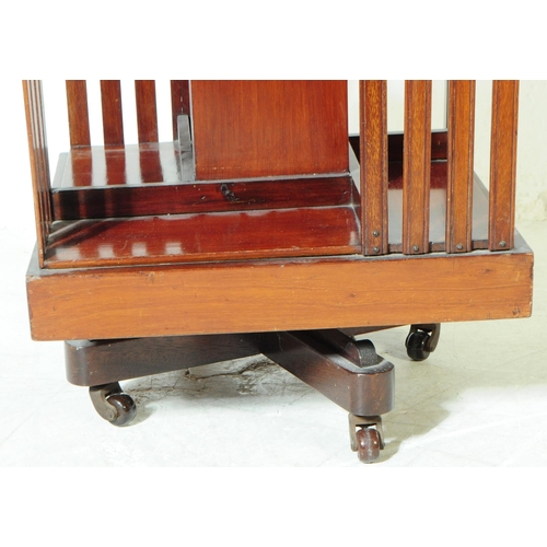 823 - An early 20th century Edwardian walnut revolving bookcase cabinet, alongside another similar desktop... 