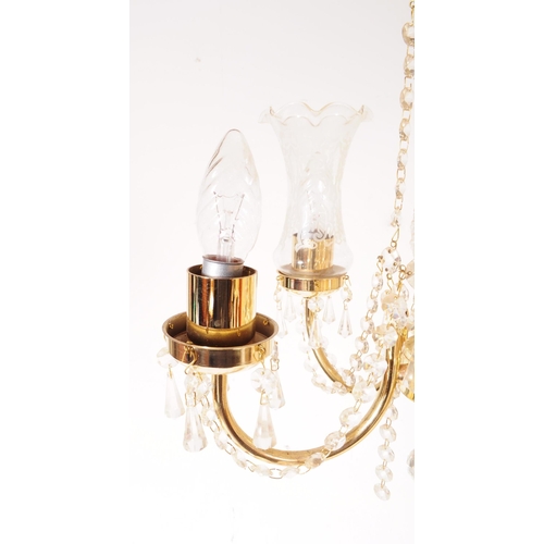 838 - An Italian made glass and brass five arm chandelier with central glass column in a spun design, with... 