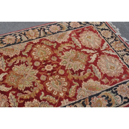 842 - A contemporary Persian Keshan manner carpet floor rug. The rug having a red central field decorated ... 