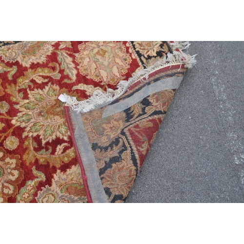 842 - A contemporary Persian Keshan manner carpet floor rug. The rug having a red central field decorated ... 