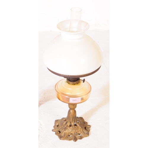 845 - Two late Victorian oil lamps; both with cast iron Nouveau style bases, one painted black the other b... 