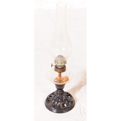 845 - Two late Victorian oil lamps; both with cast iron Nouveau style bases, one painted black the other b... 