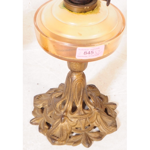 845 - Two late Victorian oil lamps; both with cast iron Nouveau style bases, one painted black the other b... 