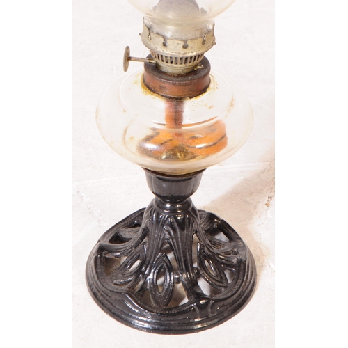 845 - Two late Victorian oil lamps; both with cast iron Nouveau style bases, one painted black the other b... 