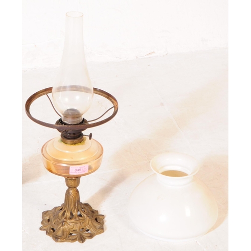 845 - Two late Victorian oil lamps; both with cast iron Nouveau style bases, one painted black the other b... 